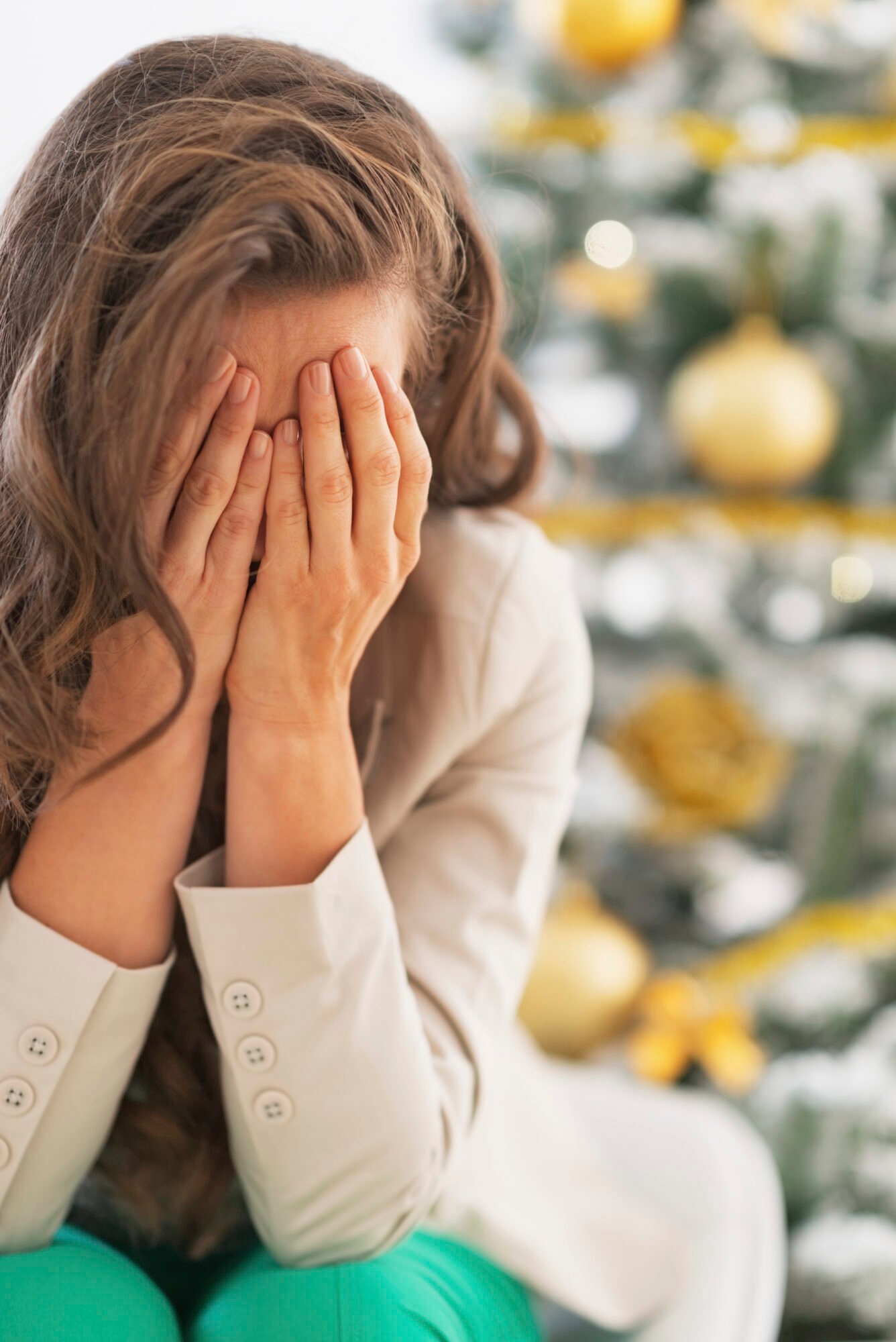 Stressed young woman near christmas tree